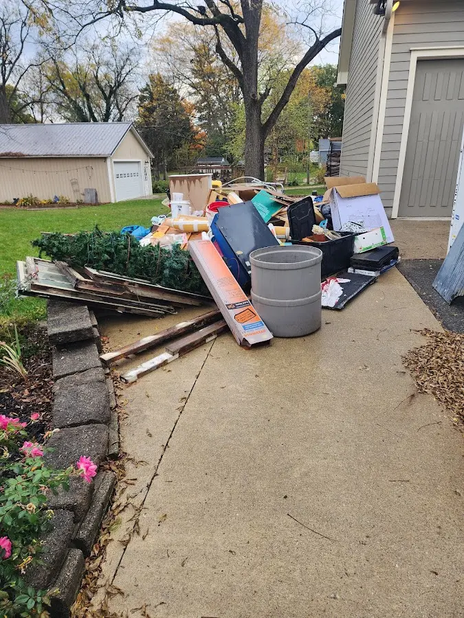 Dumpster being loaded with debris for 12 Yard Dumpster Rental in Villa Ridge
